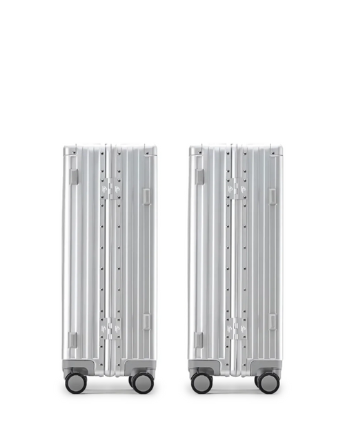 The POSHPOSH Aluminium Cabin Set seen from behind, showing the vertical shell seam and PP monogram hinge plates on both cases